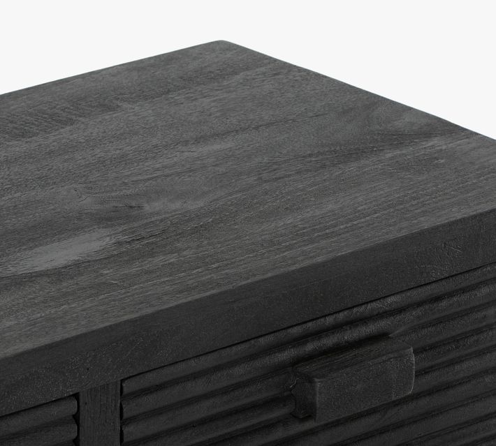 Top corner of dark wood cabinet with textured grain
