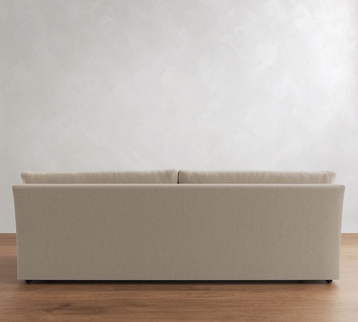 Rear view of beige sofa showing back cushions and back panel.