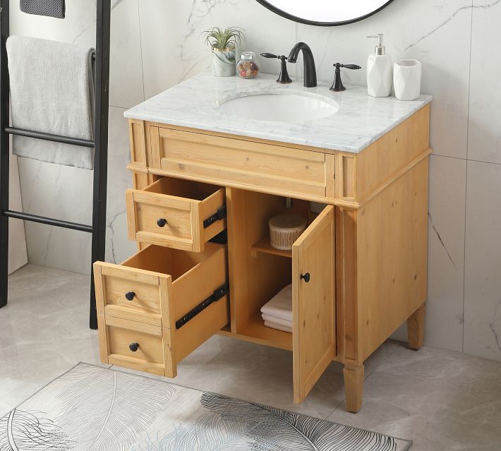 Open drawers and cabinet of wooden vanity with marble top