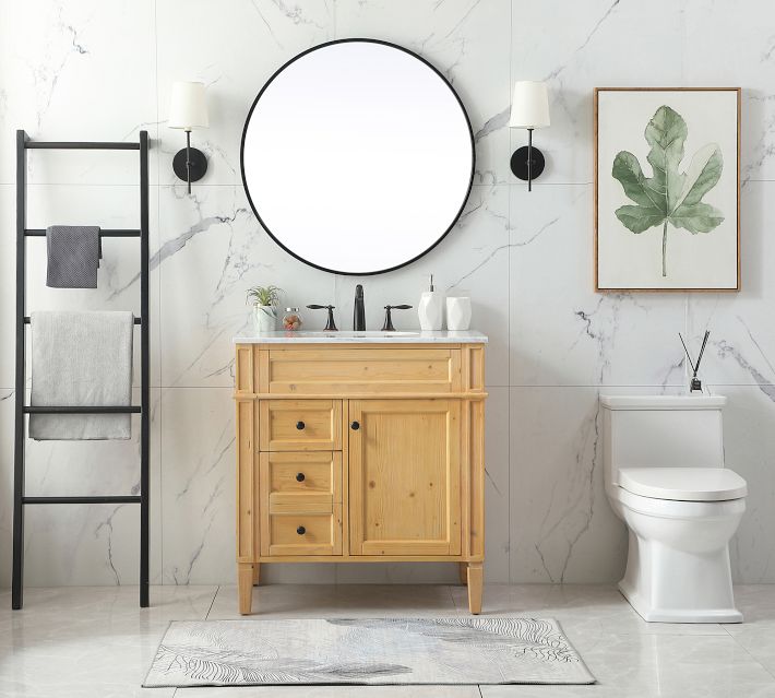 Wood vanity with marble top and round mirror reflected on wall