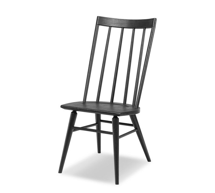 Full view of a black wooden chair with spindle back and angled legs