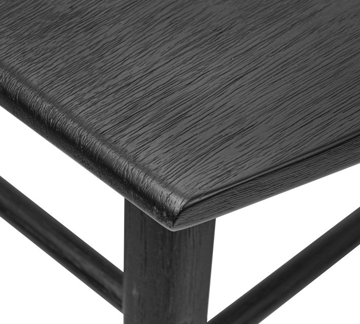 Close-up of the chair’s top edge and corner with visible wood grain