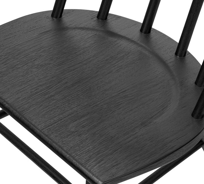 Close-up of the dark wood seat surface showing grain and rounded edge