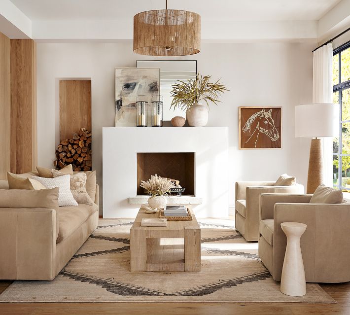 Modern living room with white fireplace, beige seating, and decor