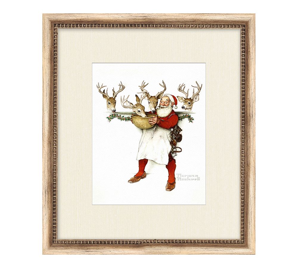 Santa and Reindeer Getting Ready Framed Print by Norman Rockwell