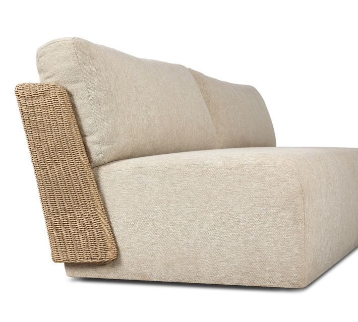 Side view of beige outdoor sofa with woven rattan armrest
