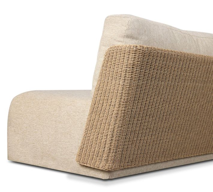 Close-up of woven rattan armrest and beige cushions