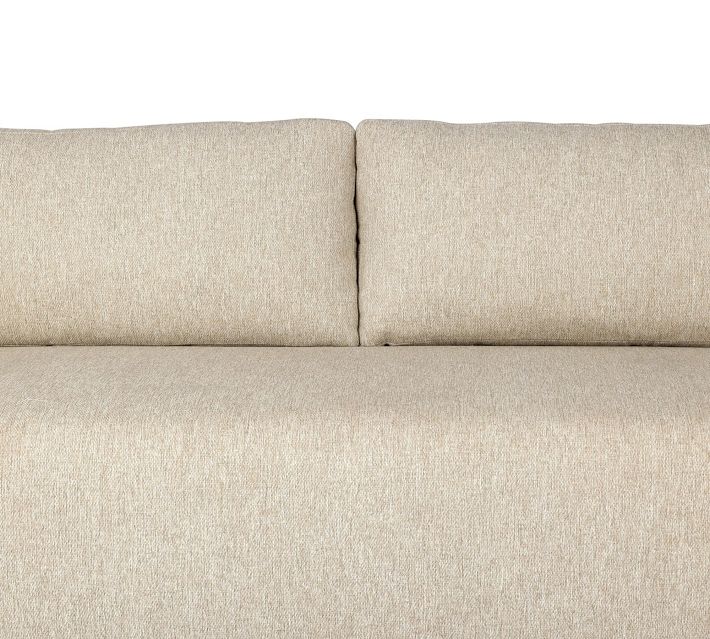 Close-up of beige sofa cushions and seam, showing upholstery texture