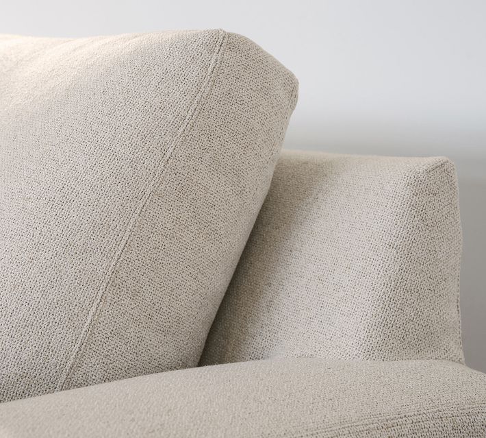 Close-up of fabric texture on the arm of the sofa, beige/light gray woven upholstery.