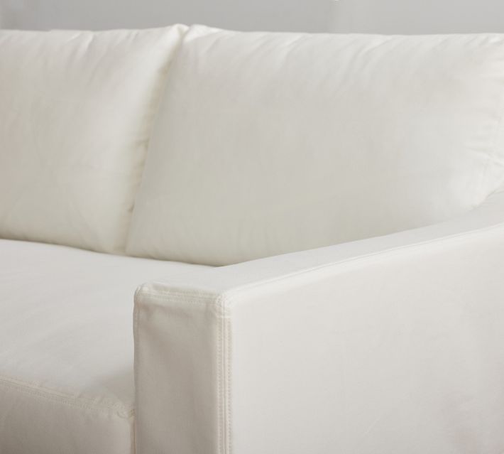 Corner of sofa arm with fabric edge and stitching