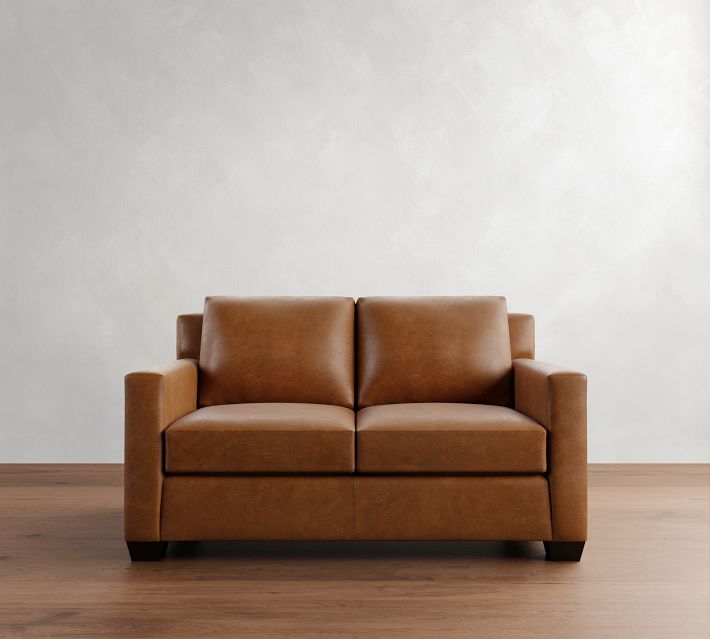 Front view of a brown leather two-seater sofa with wide arms and two back cushions.