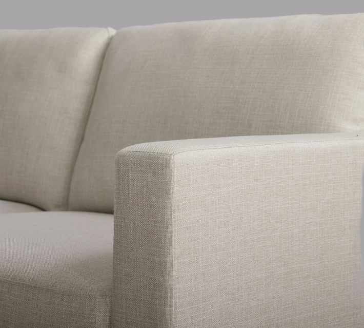 Close-up of sofa armrest and back cushion seam