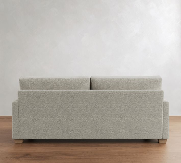 Rear view of a light gray sofa showing two back cushions