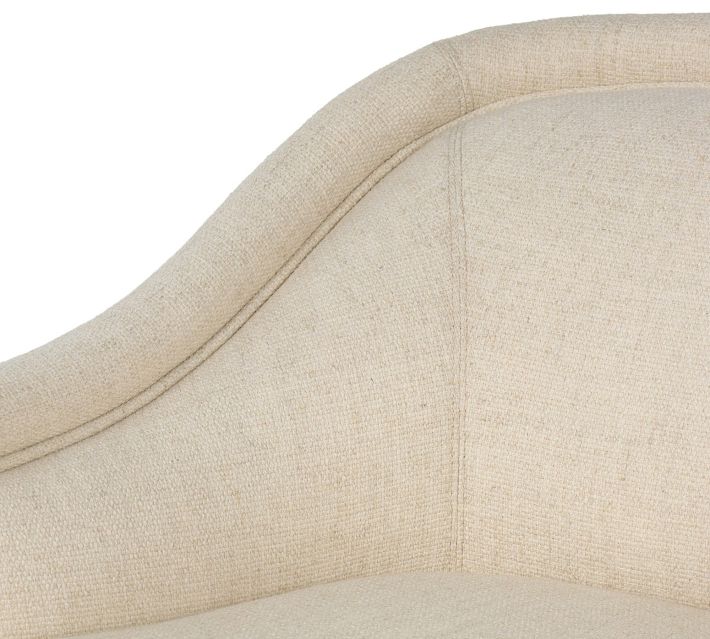 Close-up of the top edge and stitching on beige upholstered chair