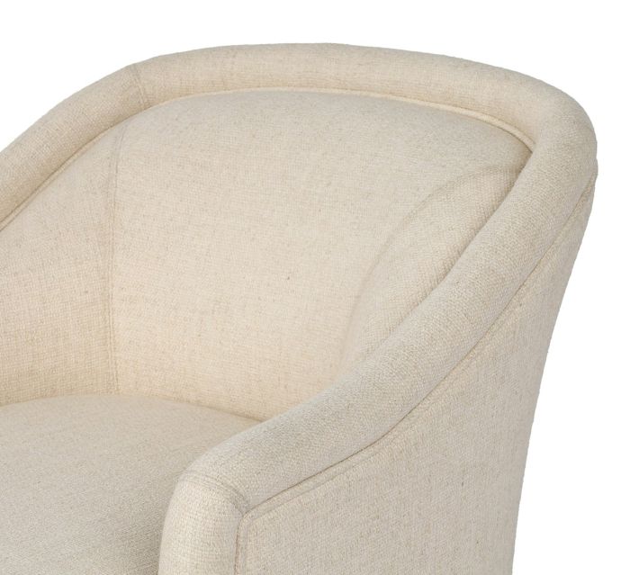 Close-up of the side and arm of beige upholstered chair showing fabric texture