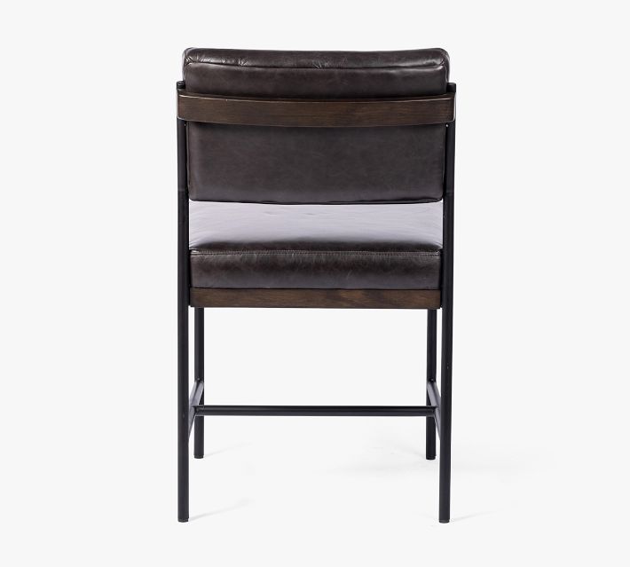 Back view of a black leather chair showing backrest and wood accent.