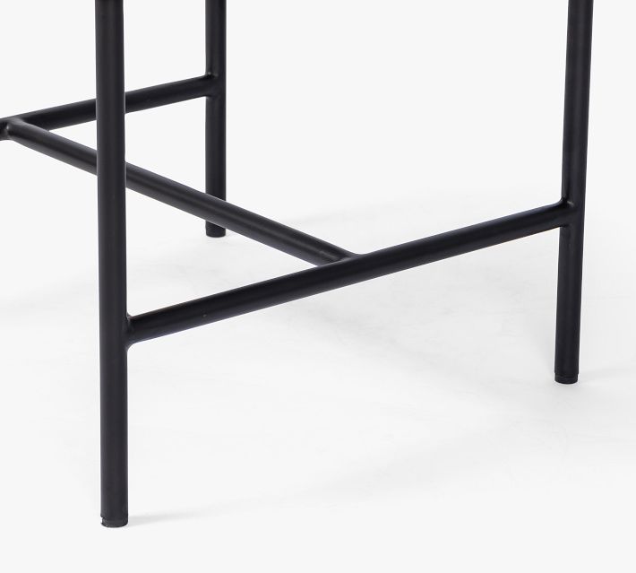 Close-up of chair leg and lower crossbars, black metal frame.