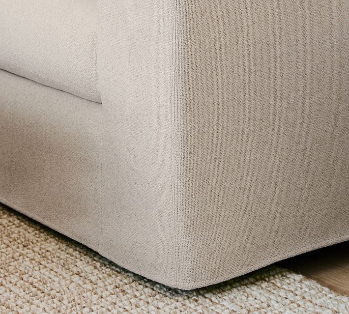 Close-up of the sofa corner showing textured fabric and seam details near the base.