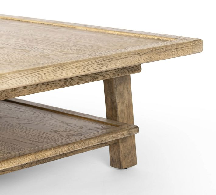 Side view of coffee table leg and base with shelf underneath