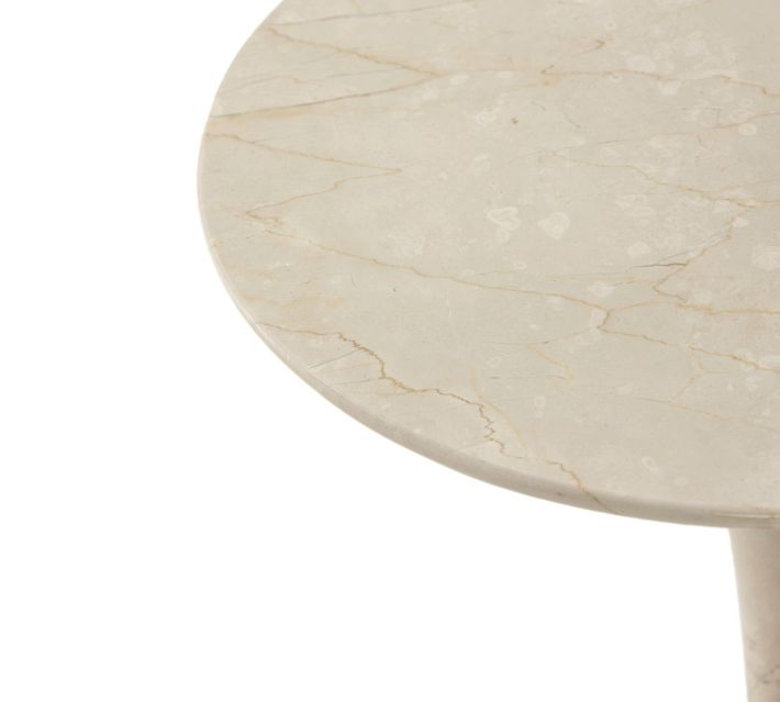 Close-up of the beige marble tabletop showing veining.
