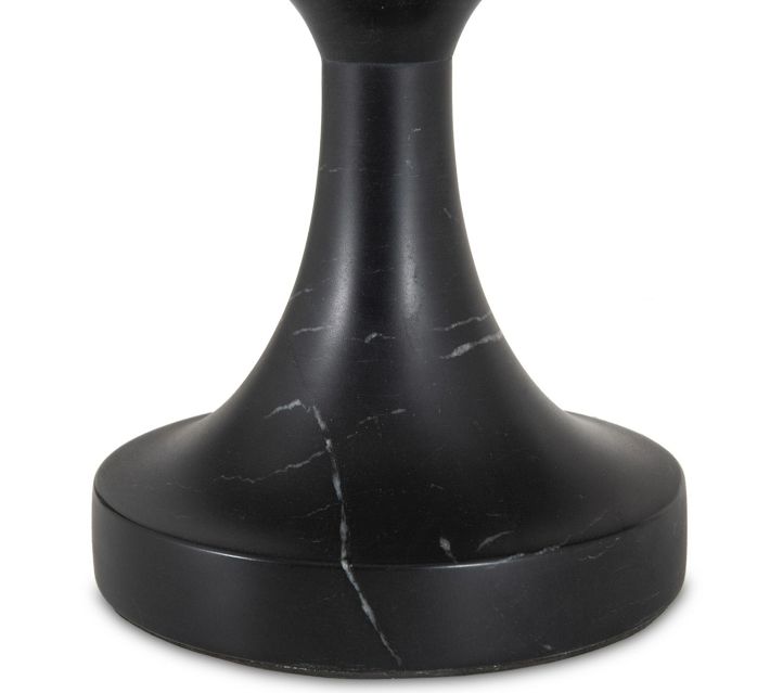 Base of the black marble table with circular foot and veining.