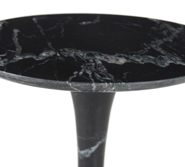 Close-up of the edge and marble texture of the round table top with marble veining.
