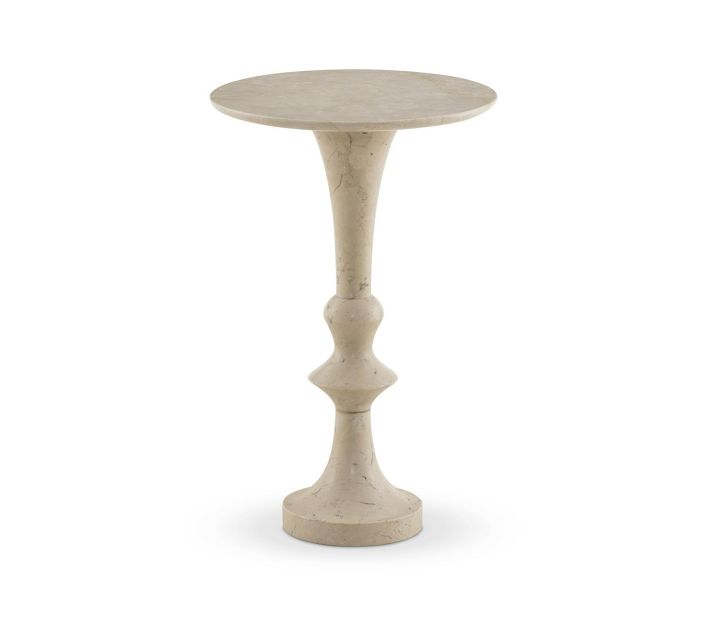 Beige marble pedestal side table with a light-colored round top.