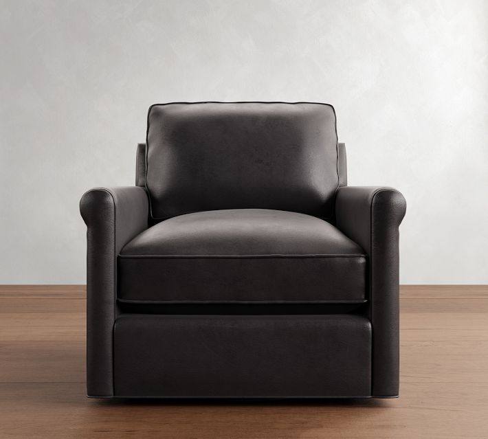 Front view of a black leather armchair with wide armrests and a single large seat cushion, coordinating with a matching lower storage drawer.