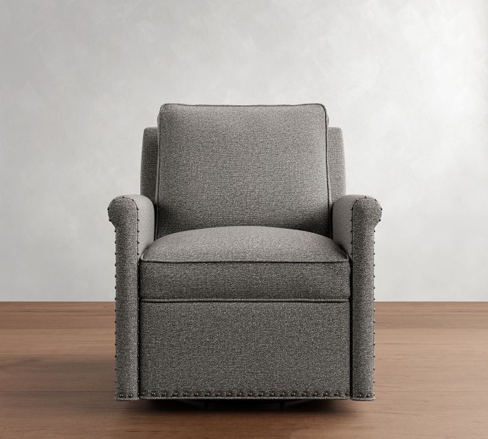 Front view of a gray armchair with nailhead trim on arms and bottom edge.