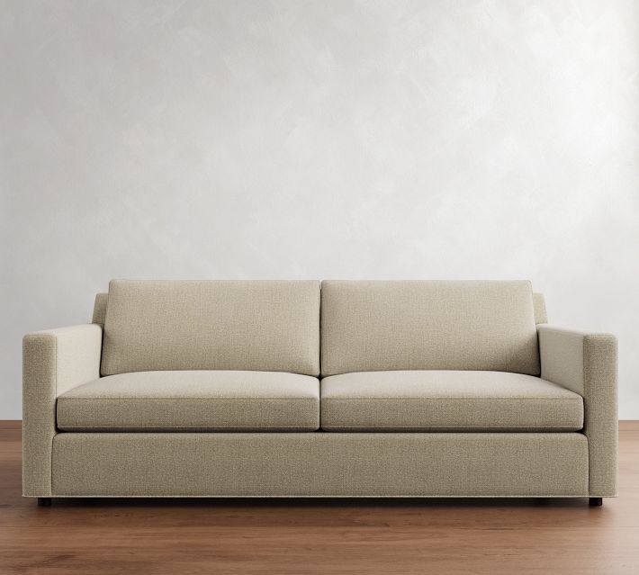 Full two-seat sofa in room with neutral background