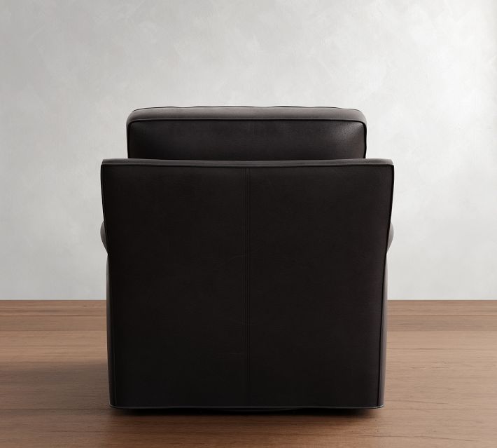 Rear view of a black leather armchair with flat back, showing the cushioned seat and back support.