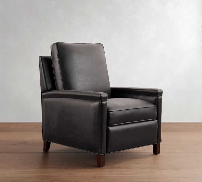 Another black leather armchair, side angle view against neutral backdrop.