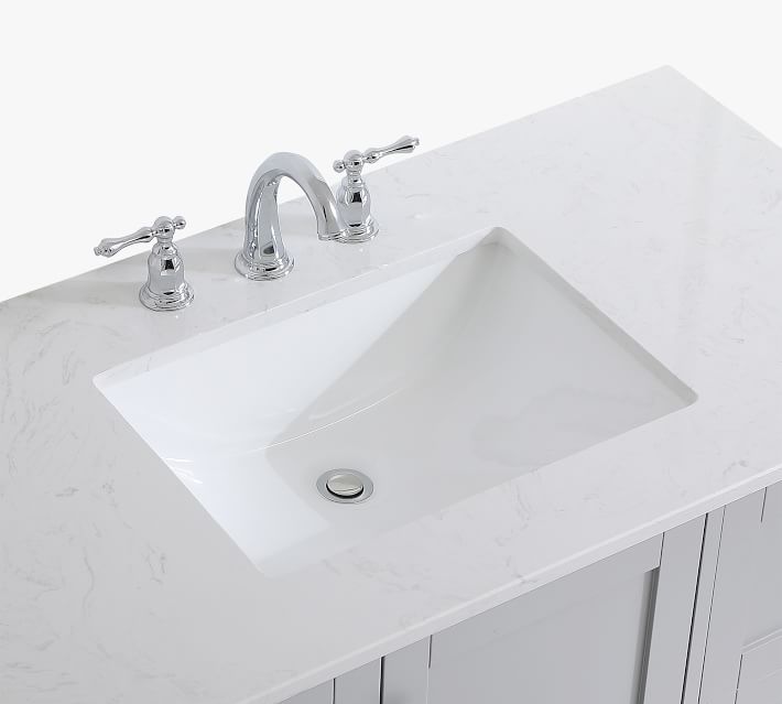 Close-up of bathroom sink and countertop edge with faucet