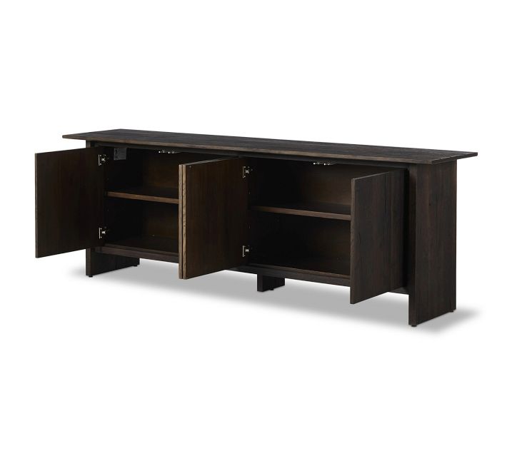 Open cabinet doors showing interior shelves of dark wood sideboard