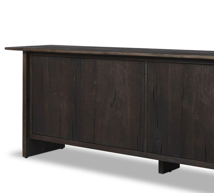 Dark wood sideboard with paneled doors, long rectangular shape