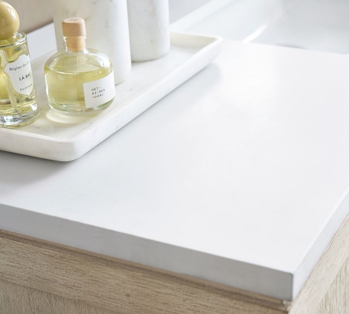 Tray with perfume bottles on a white countertop.