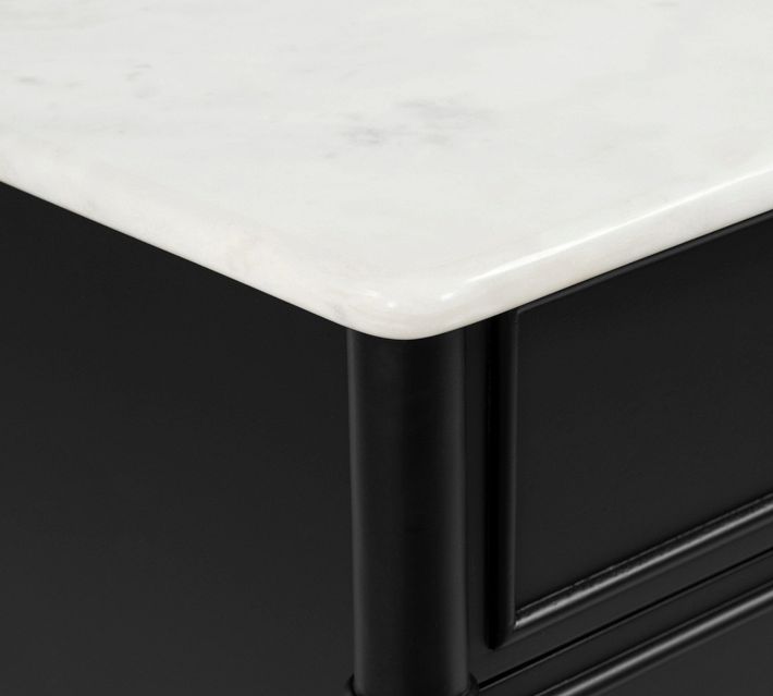 Close-up of nightstand corner and marble top edge.