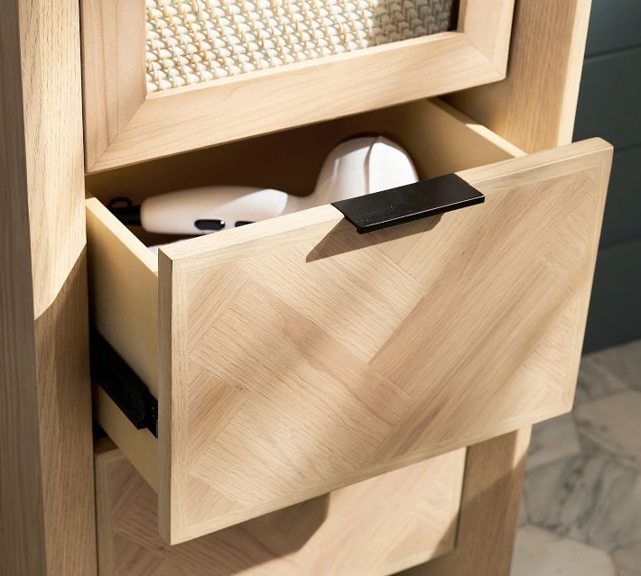 Open drawer of a wooden cabinet revealing a white electronic device and interior storage space.