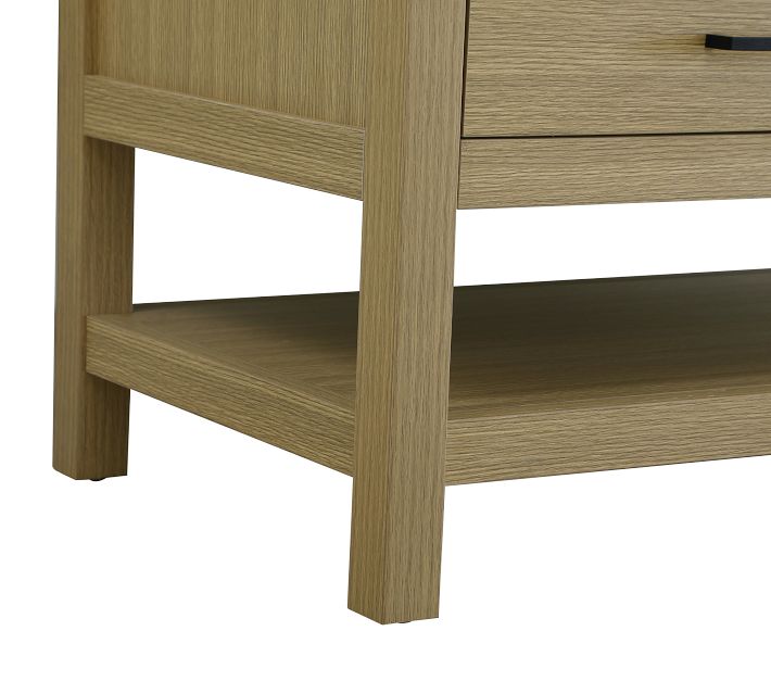 Bottom portion of a wooden vanity leg and a lower shelf, with adjustable foot in gray.
