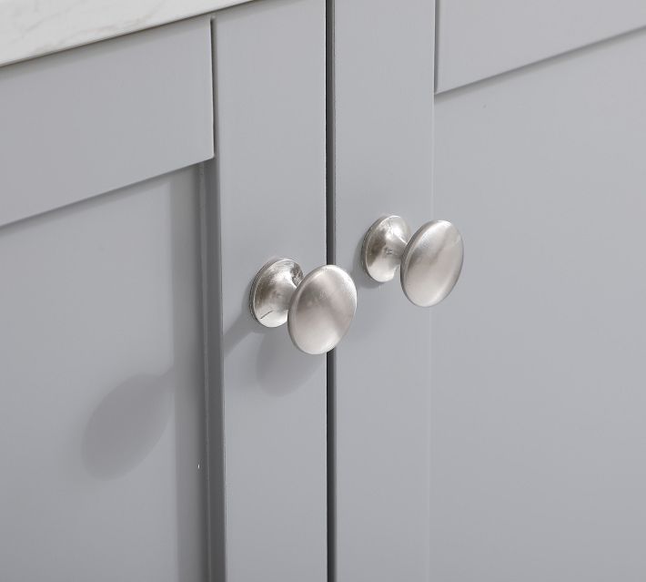 Close-up of cabinet knob/handle on light gray cabinet door