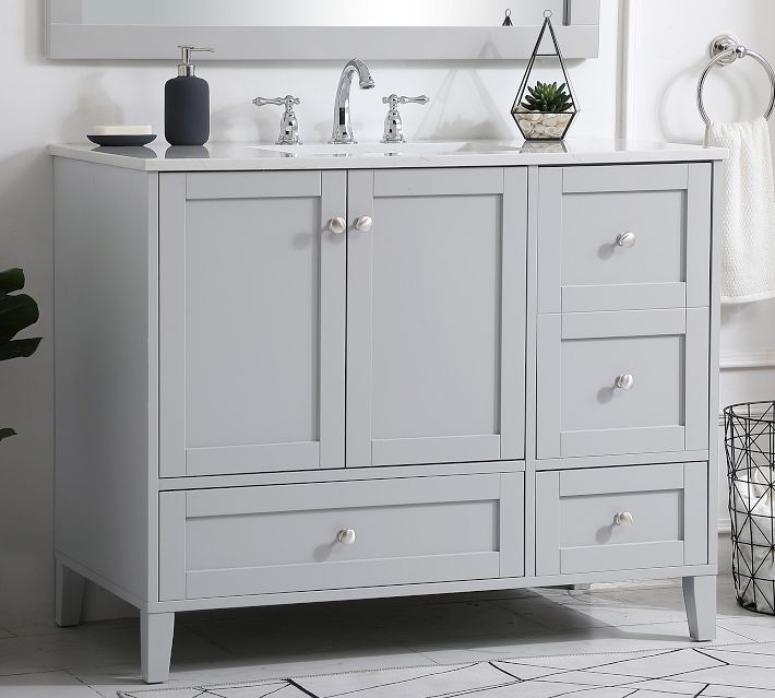 Close-up of bathroom vanity top with sink and hardware; faucet and accessories visible