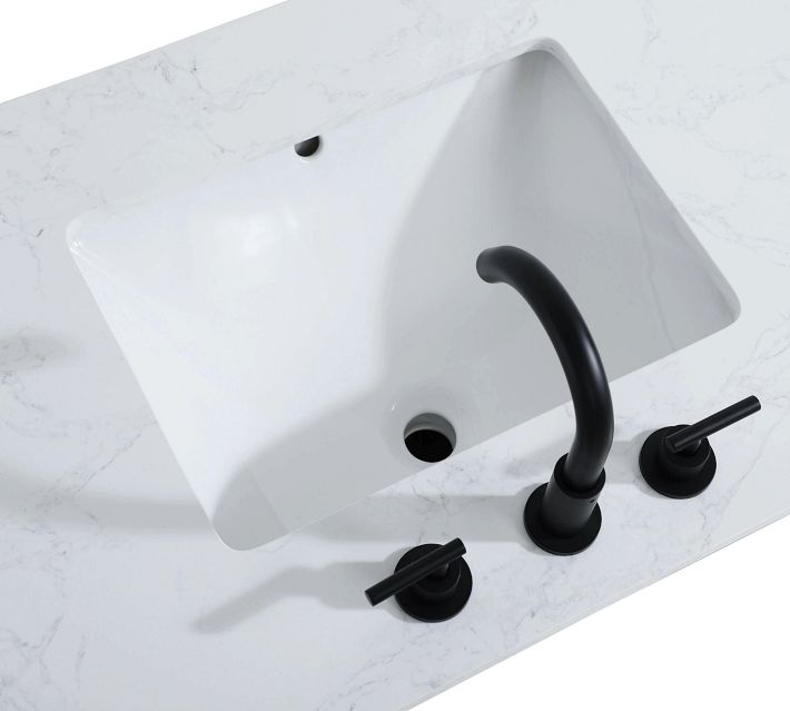 Close-up of a white double sink with black faucet and handles