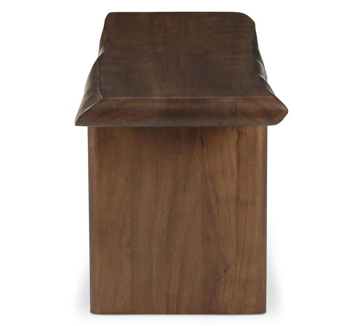 Close-up of the rounded edge and top surface of the bench, showing wood grain and beveled edge.