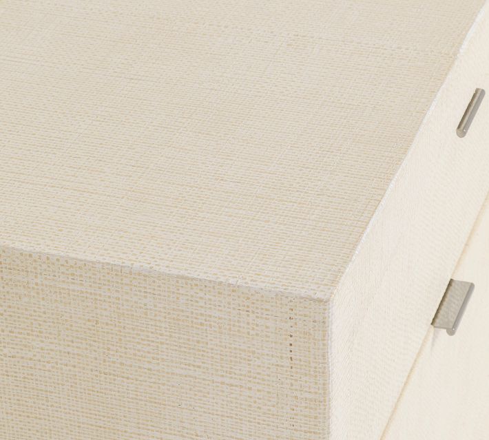 Corner view of a light beige dresser top surface and one side panel.