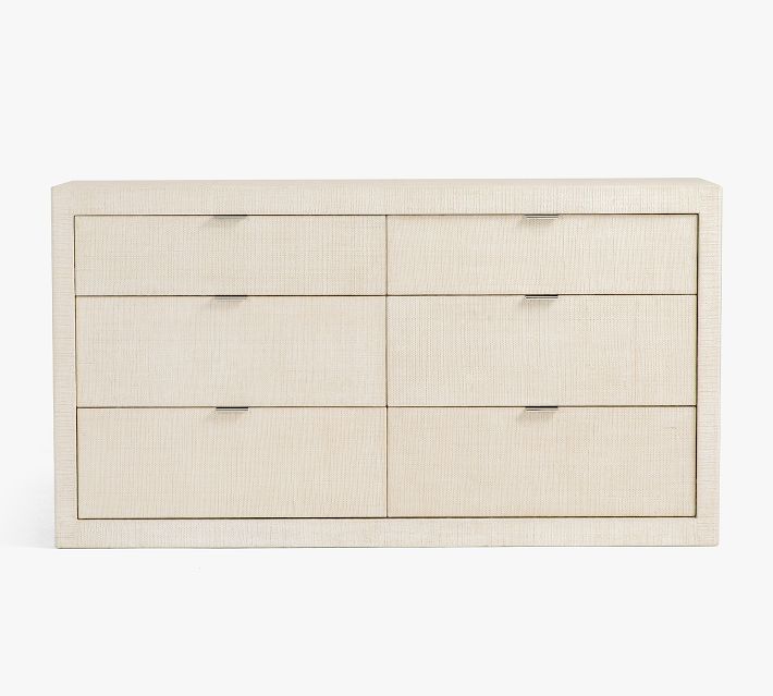 A light-colored wooden dresser with six shallow drawers arranged in two columns and three rows.
