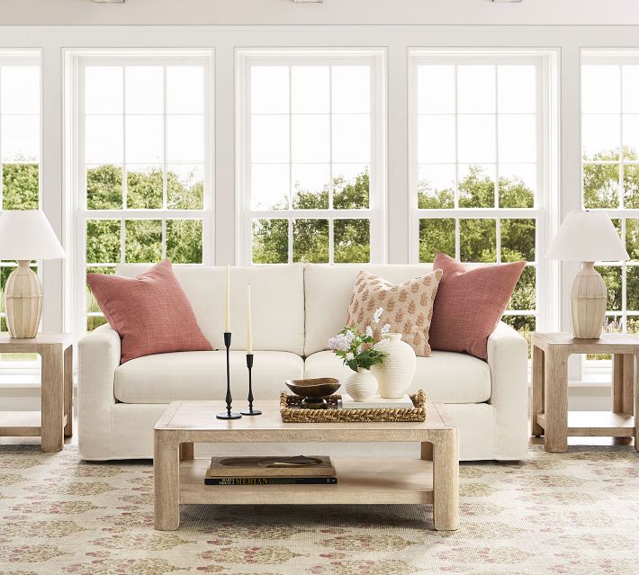 White sofa with cushions in bright room
