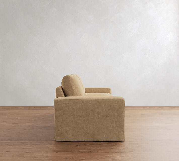 Rear view of a beige corner sofa showing back and cushions