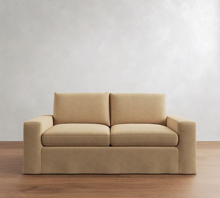 Beige loveseat with three-pillow seating