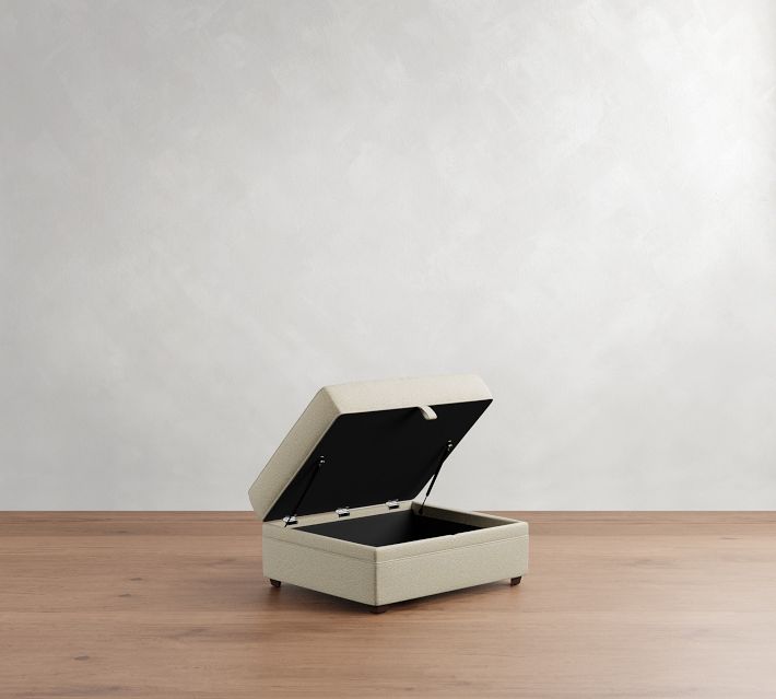 Ottoman lid lifted to reveal interior storage space and hinge supports.