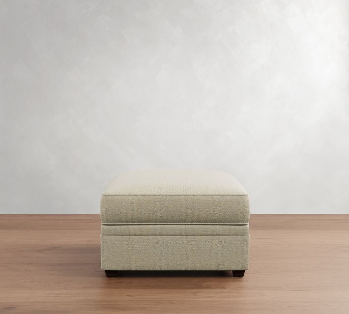 Beige storage ottoman in closed position with the lid on, showing the seam and lid edge.